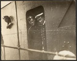 Troops loading transports. Several 15th Battalion personnel visible in porthole. Quebec 1914.
