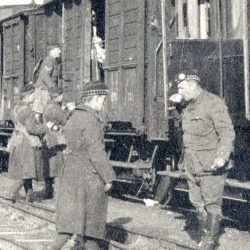Entraining in Nazaire, France Capt Duguid front drinking tea.