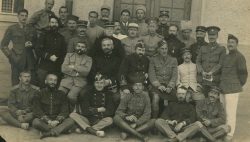 Mixed group of Allied Officer POWs. Capt Alexander seated centre right. Bischofswerda POW camp, Hannover, Germany. Undated.
